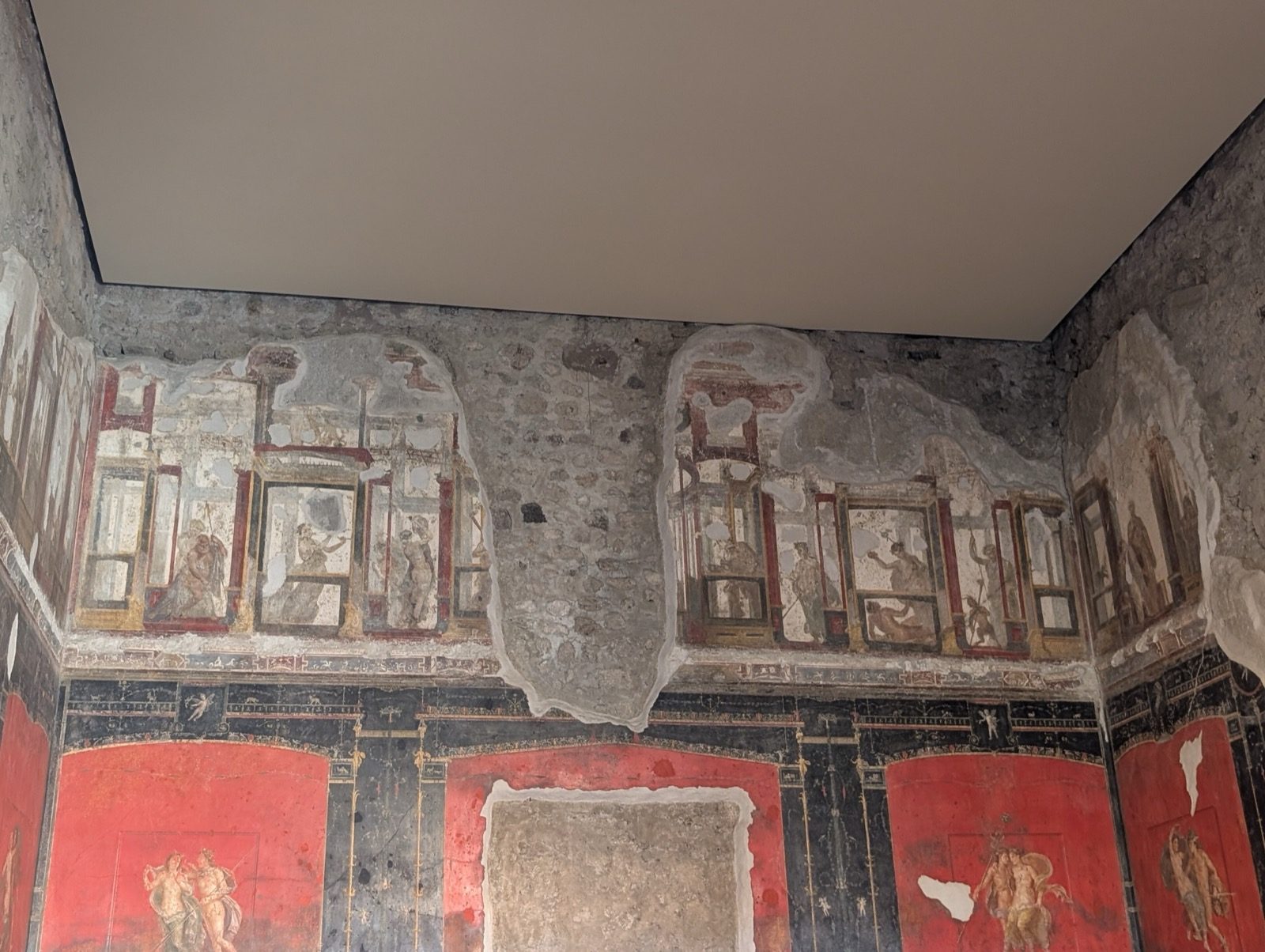 A frescoed room in the House of the Vettii, Pompeii — Fourth-Style Roman wall painting, buried in 79 CE.