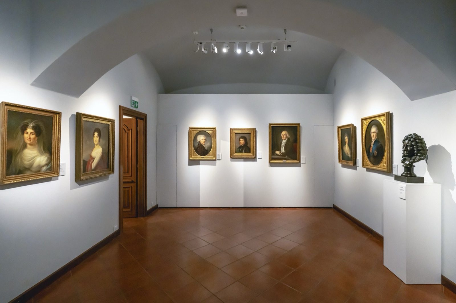 Accent lighting in a gallery — directional track spotlights pick out paintings by contrast, typically about three times the ambient level.