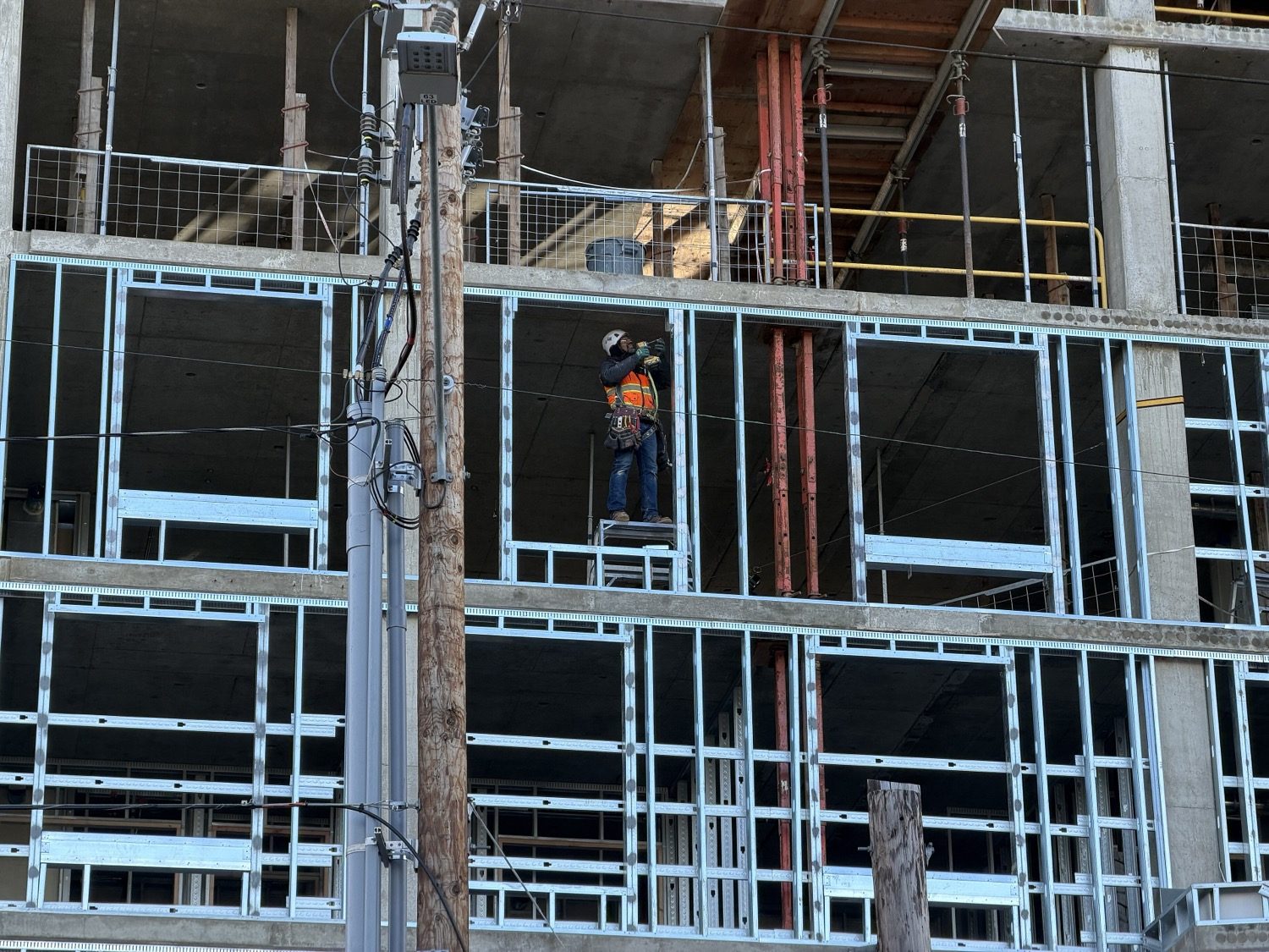 A steel-framed building under erection — rolled sections bolted into a skeleton.
