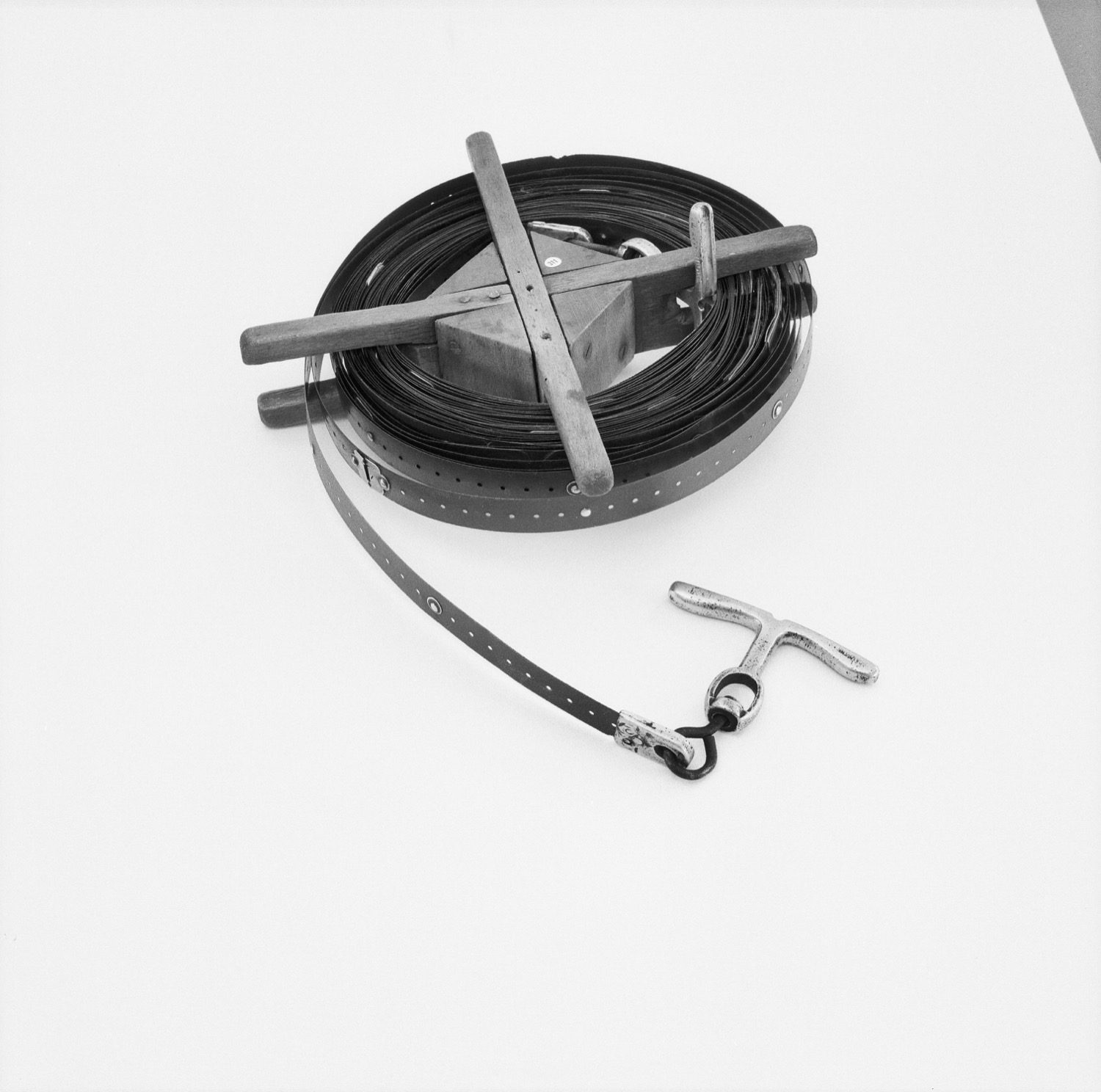 A surveyor's measuring tape laid out on the ground — linear measurement, the basis of chain survey.